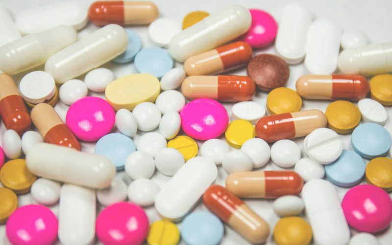 Capsules and supplements measured out on a spoon