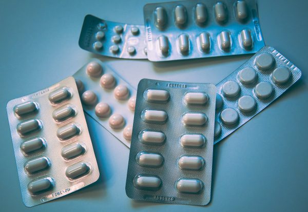 Capsules beside an amber prescription bottle