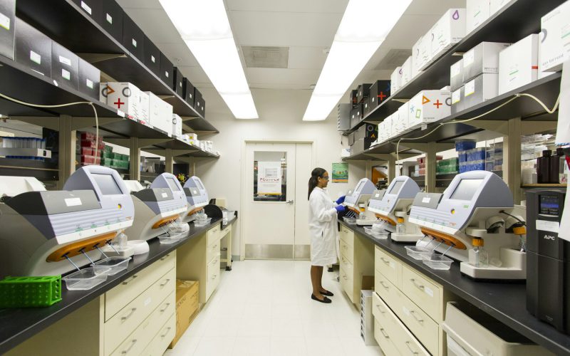 Technician working at a laboratory bench in a compounding facility