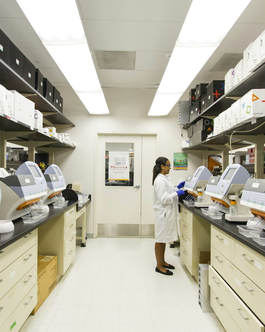 Pharmacist compounding a preparation at a laboratory bench