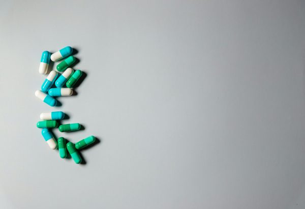 White tablets arranged on a coloured surface